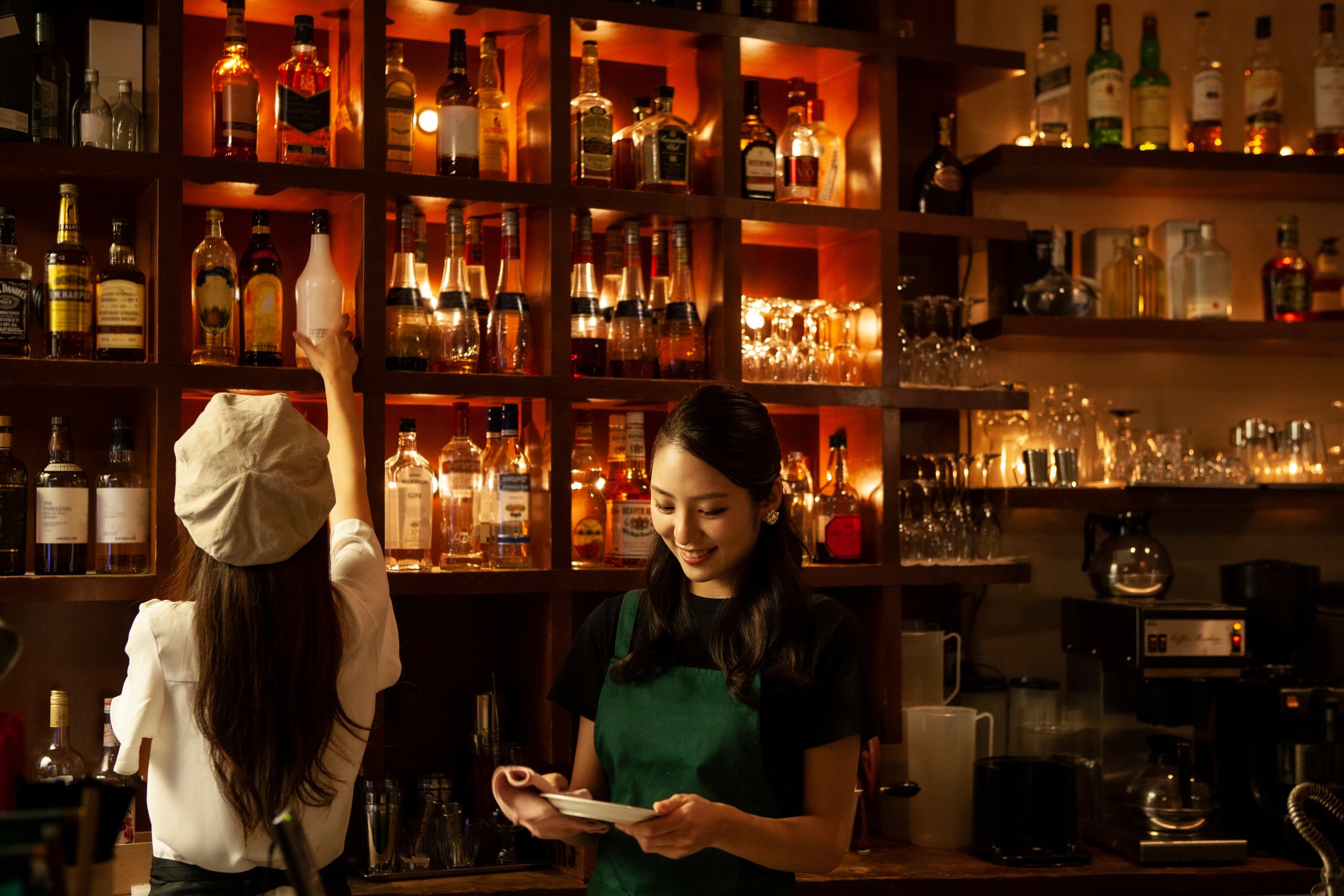 Female staff serving drinks at cafe and bar